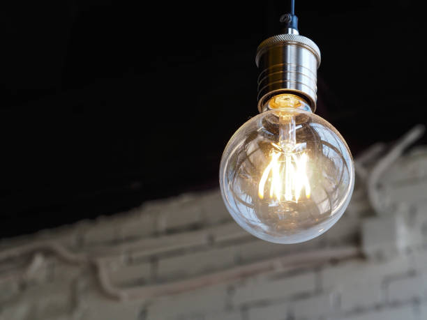 istock Incandescent lamp on a black background. 1145429882