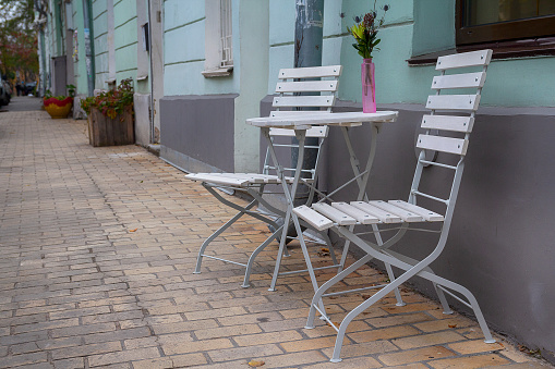 Table and chairs of street cafe on the street