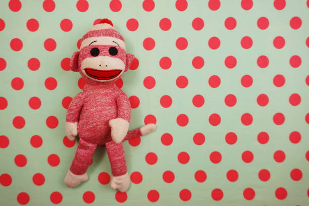 istock Pink Monkey Doll Top view on Pink and green Polka dot background 1145430028