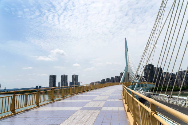 istock Bridge perspective, in the background of blue sky and white clouds 1145432128