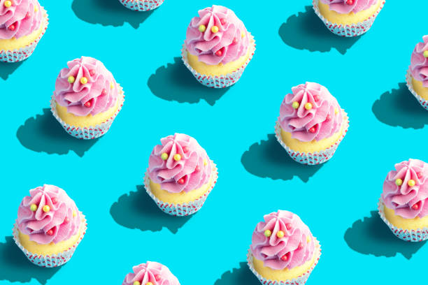 istock Colorful cupcake pattern on pastel blue background. Creative minimal party concept. 1145432411