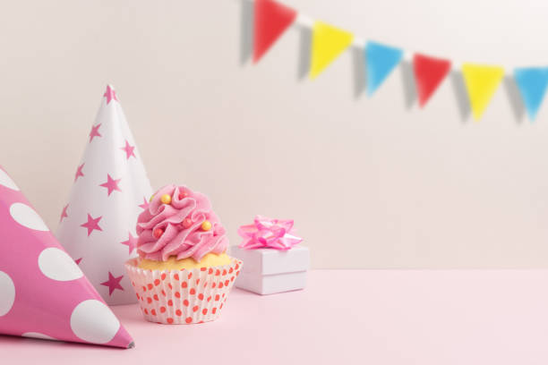 istock Colorful celebration background with various party decoration and cupcake. Minimal party concept. 1145432414