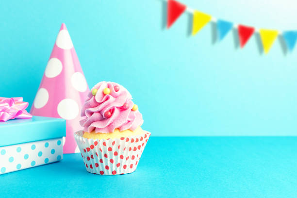 istock Colorful celebration background with various party decoration and cupcake. Minimal party concept. 1145432420