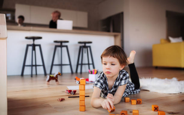 istock A small girl playing on the floor at home. 1145433431