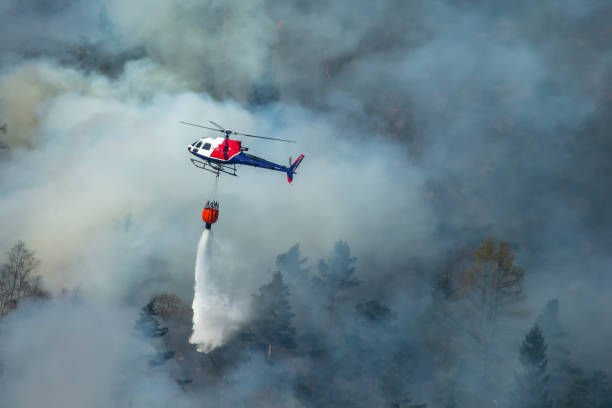 Helicopter extinguishing wildfire. Bergen, Norway. stock photo