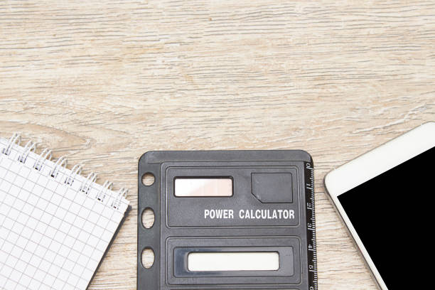 istock calculator, notebook and smart phone on wooden background 1145434769