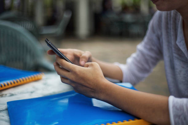istock Young woman on the table texting 1145435924