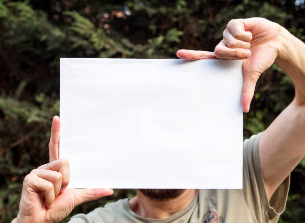 istock man holding up the poster,blank billboard.banner 1145437171