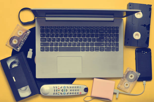istock Modern digital gadgets, storage media, devaysy and obsolete analog media devices on a yellow paper background. Top view. Flat lay. 1145447224
