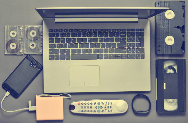 istock Modern digital gadgets, storage media, devaysy and obsolete analog media devices on a gray paper background. Top view. Flat lay. 1145447247
