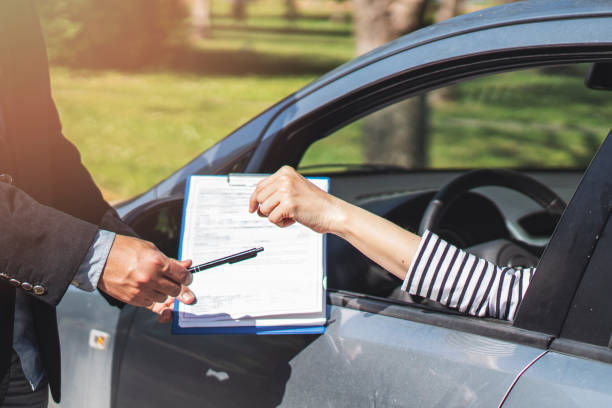 istock Businessman giving car key, application document with pen 1145447270