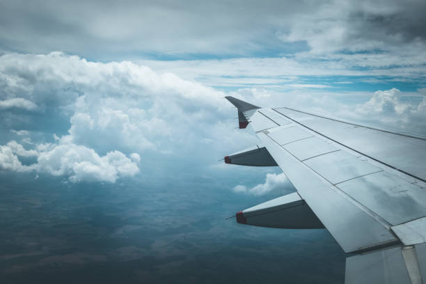 Airplane wing through the aircraft window. Greenhouse effect, global warming. stock photo