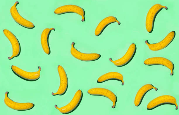 istock Creative background of ripe bananas on blue surface. Top view. 1145449276