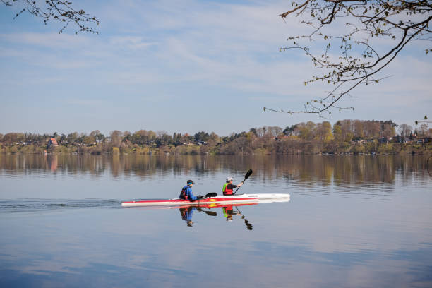Farum, Denmark - April 20, 2019: Two people in kayaks on Furesøen, one of the largest freshwater lakes in Denmark