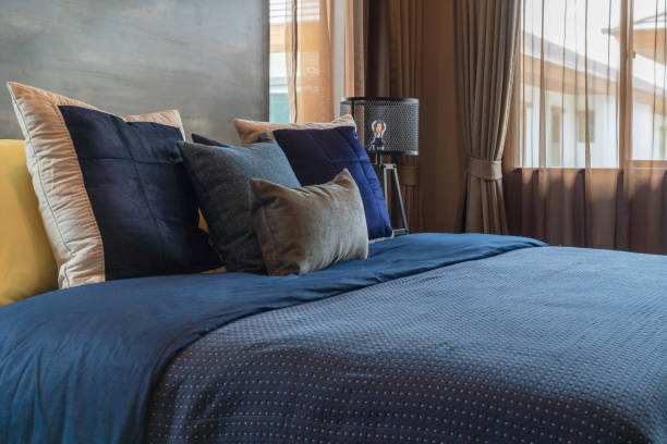 Interior of modern urban town house in North America. Bedroom with Queen size bed.