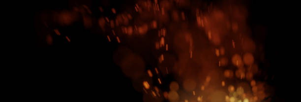 istock flying sparks from fire in front of black backgound 1145452911