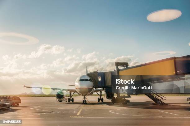 Airplane In An Airport Stock Photo - Download Image Now - Passenger Boarding Bridge, Airport, Window