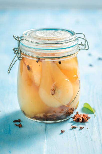 istock Homemade and sweet pickled pears on blue table 1145455576