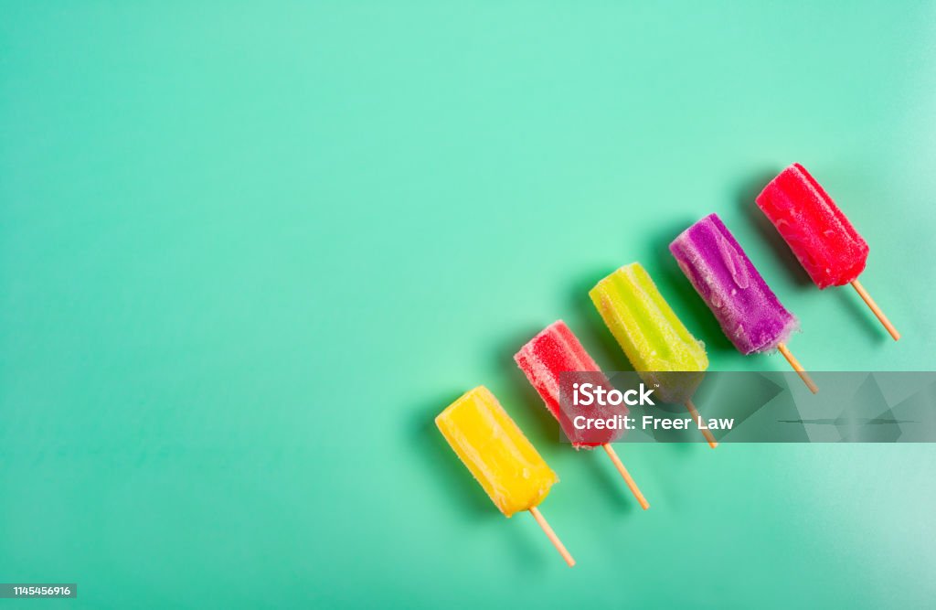 Multiple Color Popsicle Multicolor Popsicles Line Up On Green Background With Copy Space Stock ...