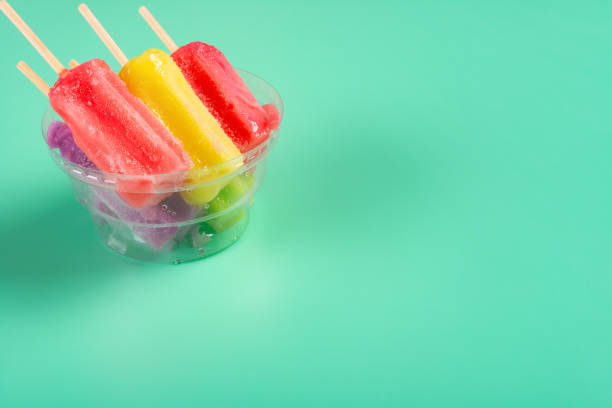 istock colorful popsicles melting in a cup on light green with copy space 1145457008