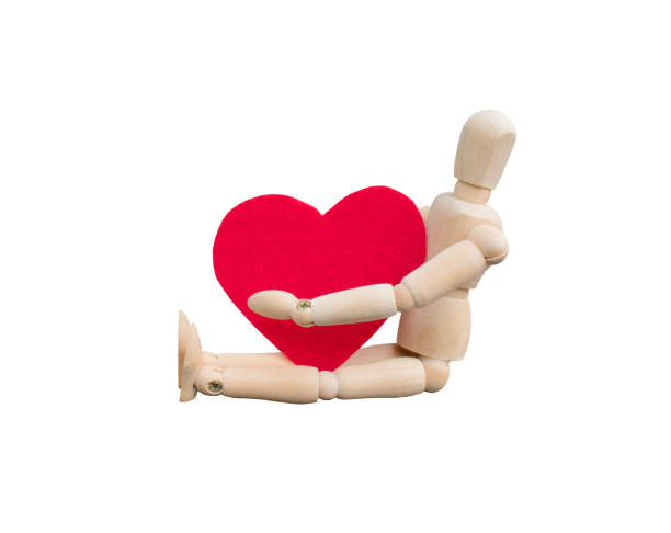 istock Wooden dummy hugs a heart, Valentine's day concept. 1145458298