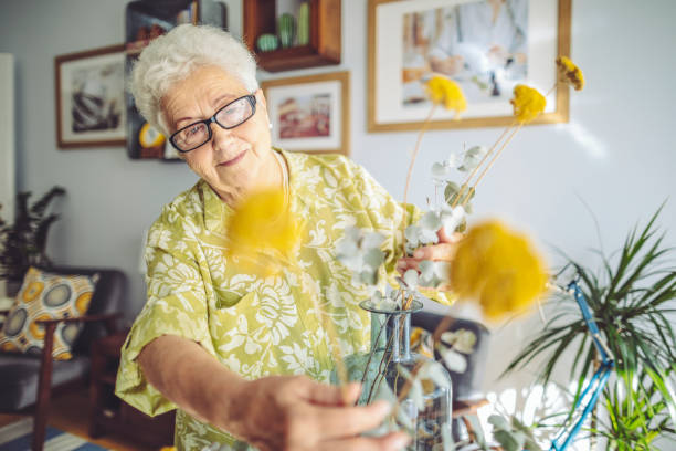 senior woman at home - adult beautiful caucasian equipment imagens e fotografias de stock