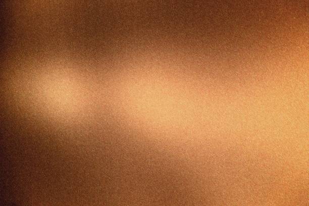 istock Glowing bronze rough metal wall, abstract texture background 1145460649