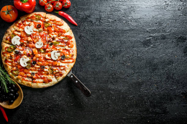 istock Pizza with olives, sausages and tomatoes. 1145460690
