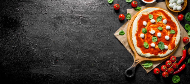 istock Preparation of fresh homemade pizza with spinach and mozzarella. 1145463942