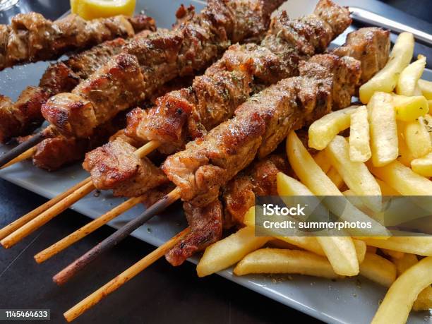 Souvlaki Greek Etnic Food Mear Roasted In A Plate Wiht Lemon And Potatoes Stock Photo - Download Image Now