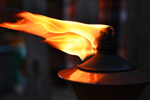A close up image of the flame on a citronella torch.
