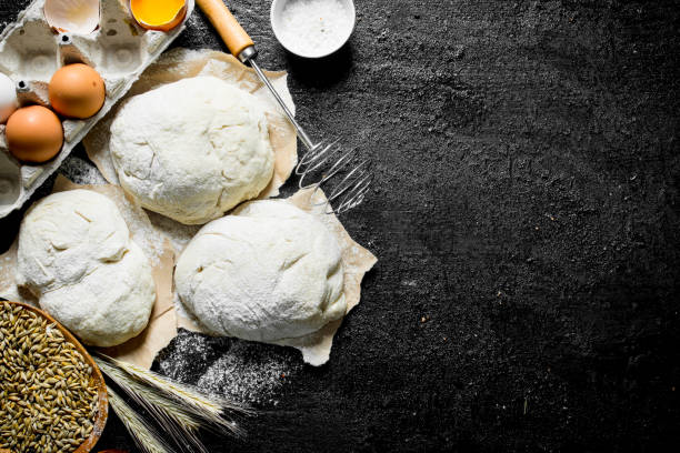 istock Pieces of dough with eggs, grain and spikelets. 1145467596