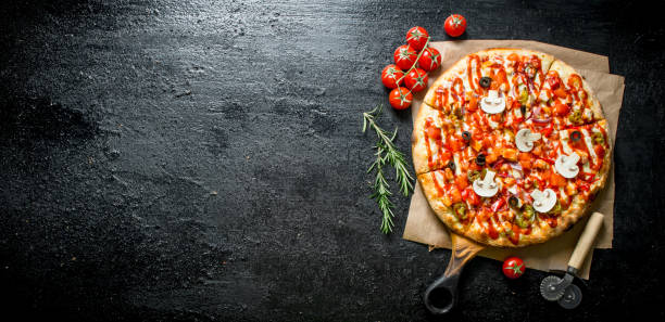 istock Fragrant pizza with tomatoes and rosemary. 1145468312