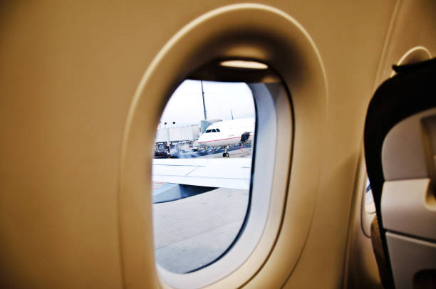 Airplane window framed image of airport
