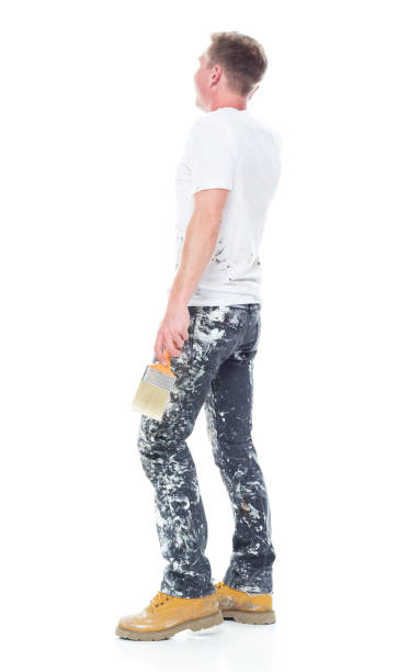 istock Handsome young white man who is a painter - talking on smart phone 1145469312