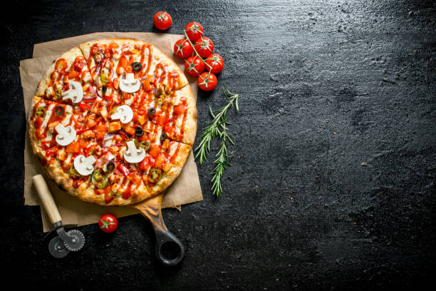istock Fragrant pizza with tomatoes and rosemary. 1145469605