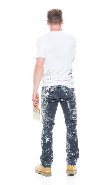 istock Handsome young white man who is a painter - texting on smart phone 1145469804
