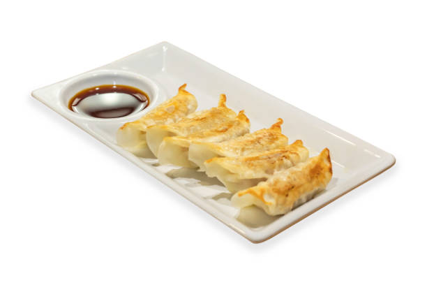 istock Gyoza and sauce in plate on a white background with clipping path. 1145470648