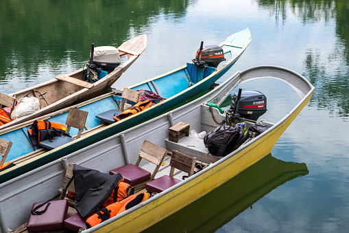 Long boats moored on Batang Ai lake in Borneo. The boats are the only method to get around the dense rainforest.
