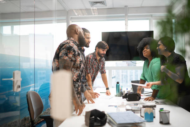 Business team discussing plans during business meeting Business team discussing plans during business meeting african descent analyzing business white stock pictures, royalty-free photos & images