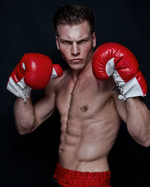 istock Sexy male boxer on black background 1145472359