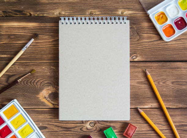 istock Notebook with stationery on wooden background 1145472626