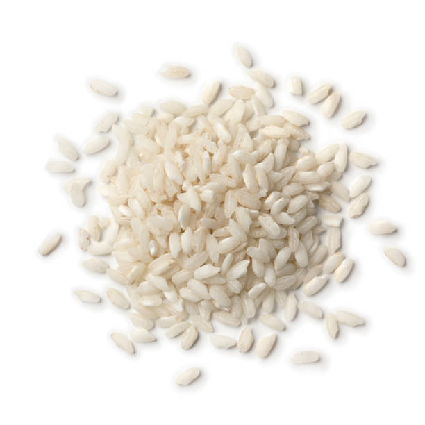 Heap of Carnaroli risotto rice Heap of Italian Carnaroli risotto rice isolated on white background rice cereal plant stock pictures, royalty-free photos & images