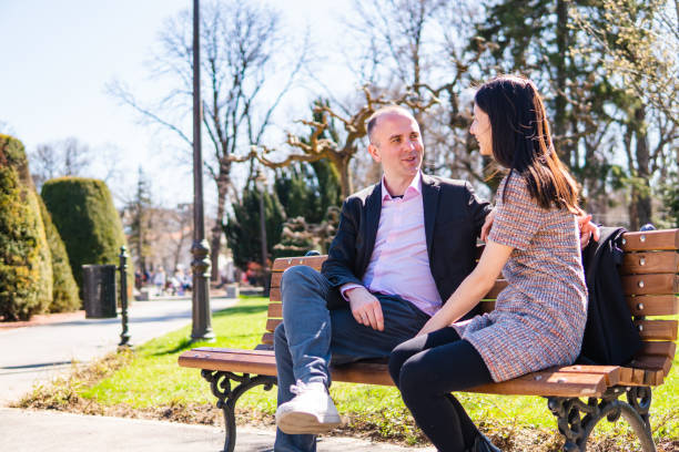 istock Multiethnic couple on a park bench 1145474421