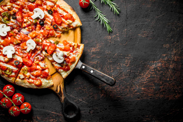 istock Sliced fragrant Mexican pizza on a cutting Board. 1145474445
