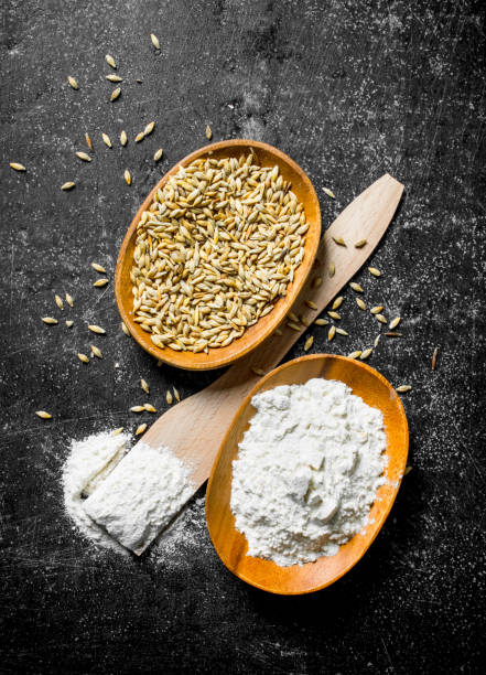istock Flour on a wooden spatula and bowl with grain. 1145475445