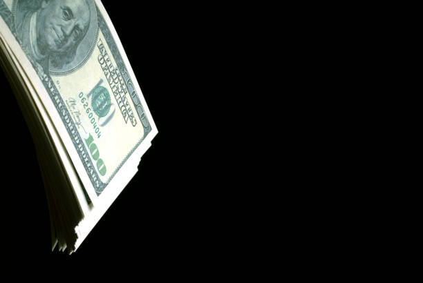istock USD dollar banknotes in the dark. 1145475660