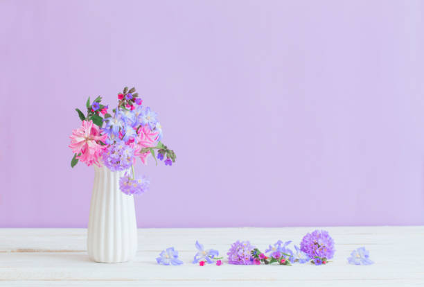 istock blue and pink flowers in vase on white table 1145476278