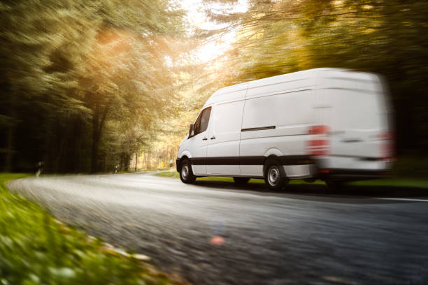 delivery van drives on a road - business speed horizontal commercial land vehicle imagens e fotografias de stock