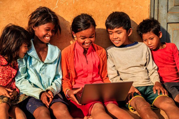 istock Happy Cambodian children using laptop on a schoolyard, Cambodia 1145477825